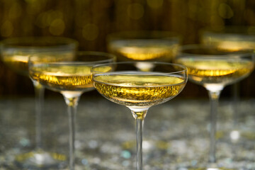 Bubbly champagne wine in a coupe glasses ready to drink, selective focus.