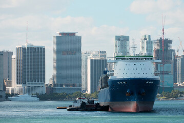 Berthing Of The Cargo Ship With Foreward Accommodation With Tug Boat Assistance With Skyscrapers In The background, Mooring Maneuevering, Ship Handling © I am from Mykolayiv