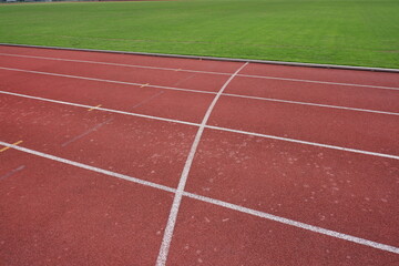 Fototapeta premium Aerial Close up Athletic Running Track with Green Grass Background Detail