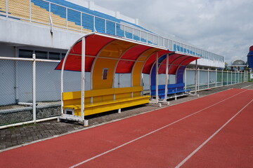 Brightly Painted Detail Dugout in Colorful Sports Stadium on Sunny Day