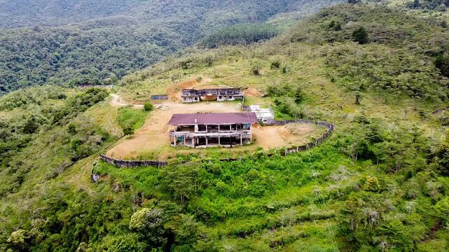Aerial View of Abandoned Building on Lush Mountain Hillside