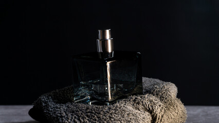 Upright perfume bottle placed on textured cloth under subtle lighting, emphasizing sophistication, beauty, and modern product aesthetics for fragrance or cosmetic themes.