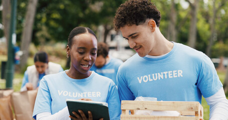 Tablet, volunteer and team with people in park for donation, community service and ngo project. Nonprofit checklist, grocery distribution and food drive with man and woman with tech for charity