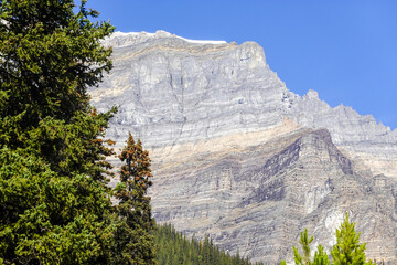 Distant cliffs and forested slopes in mountain landscape