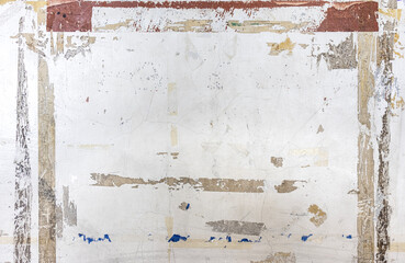 A concrete wall with a grunge texture, marked by the lingering residue of adhesive tape