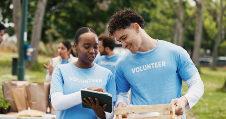 Outdoor, volunteers and discussion with tablet, charity and happy for inventory on web or donations. Humanitarian, people and supply distribution with tech, NGO and social responsibility in woods