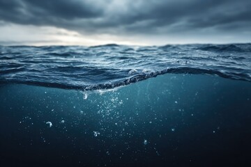 Moody ocean surface, dark storm clouds above. Bubbles underwater