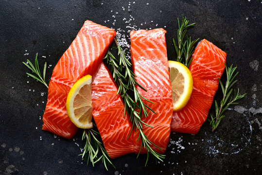 Raw fresh organic trout fillet with ingredients for cooking . Top view with copy space.