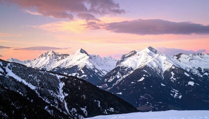 A panoramic view of snow-covered mountain peaks under a vibrant pink and purple sky at dusk.