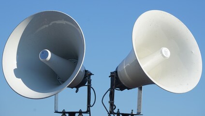 Dual Horn Speakers Against a Blue Sky