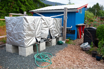 Three water storage tanks at a community garden for rain catchment