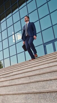 Successful businessman walking down marble stairs in front of glass office building confident modern leader symbol of ambition success motivation professional lifestyle and financial independence