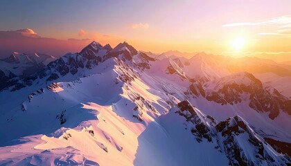 A breathtaking aerial view of a vast, snow-covered mountain range at sunset, with the sun casting a warm, golden light over the rugged peaks.