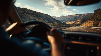 Driving through scenic mountain highway, person grips steering wheel, surrounded by breathtaking landscapes. sun casts warm glow on road, enhancing sense of adventure and freedom