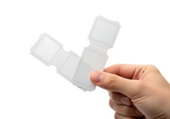 Hand holding blank white tickets with perforated edges image