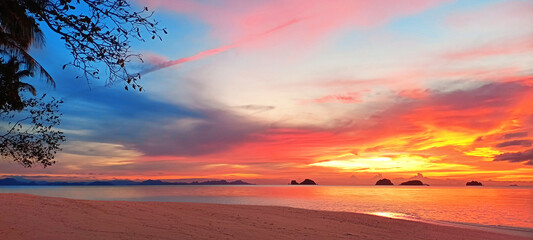 Sea sunset, tropical island beach sunrise, beautiful ocean landscape, colorful red orange pink yellow sky clouds over water, golden sun light, coconut palm trees silhouette, summer holidays, travel