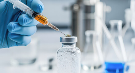 Vaccine and medical research concept with scientist hand holding syringe and vial, doctor preparing injection for vaccination or treatment in modern laboratory
