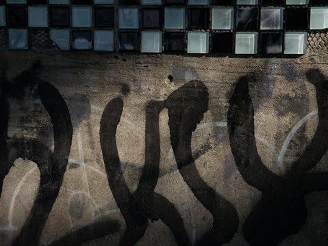 Old dirty cracked glass block tiles in black and white checkered pattern with scratches and deterioration - Powered by Adobe