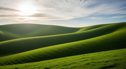 Rolling green hills under a bright, partly cloudy sky, creating a serene landscape.