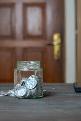Coins in a glass jar. Saving money. Money-saving concepts, savings. Coin collection.