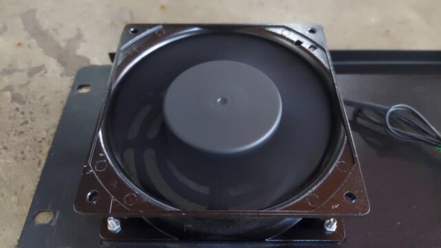 Close-up of a mini exhaust fan spinning, showing rotating blades, airflow motion, and compact ventilation equipment commonly used in small rooms or workspaces.
