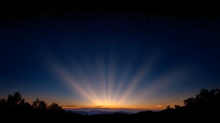 Vibrant sunrise with crepuscular rays bursting over silhouetted mountains and trees against a starry twilight sky