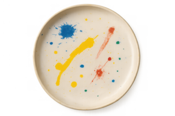 Ceramic plate showing colorful paint splatters, an abstract modern art design, creativity and individuality concept