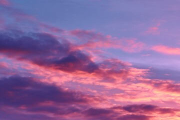 Fototapeta premium Beautiful sunrise sky with soft clouds in gentle hues of pink and purple over a tranquil landscape