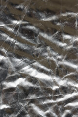 Shiny flat crumpled surface of silver reflector