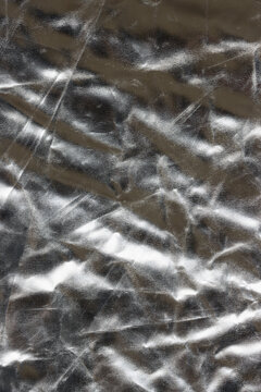 Shiny flat crumpled surface of silver reflector