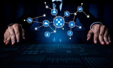 A businessman engages with a digital network interface, showcasing icons that represent innovation and technology, indicating a modern workplace interconnectedness. Tessel