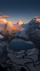 Majestic Alpine Peaks with Reflecting Lake at Sunrise