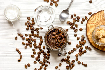 Body scrub of ground coffee top view on wooden table
