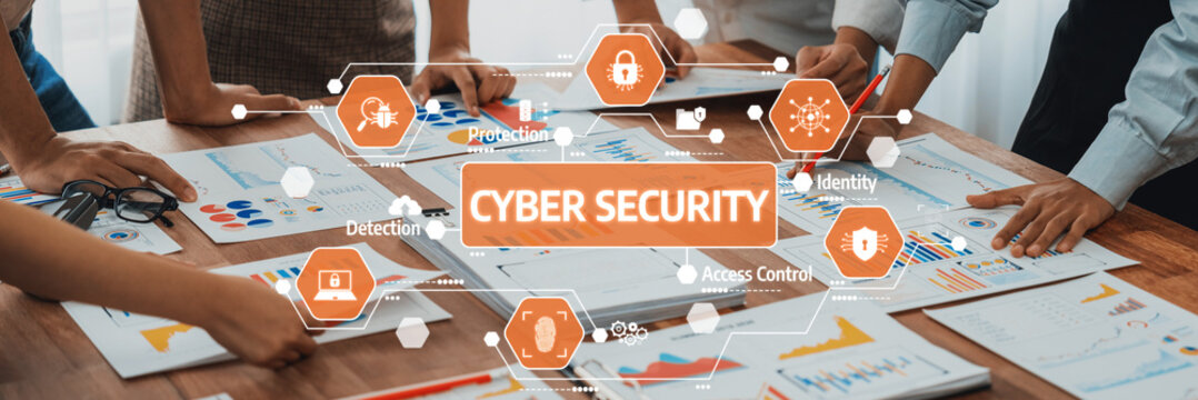 A diverse group of individuals working together on cyber security strategies in a modern office, featuring digital icons and analytical charts on the table. Amity