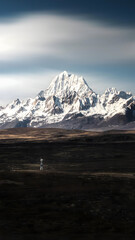 Majestic Snowcapped Mountain Peak Above Vast Plateau Wilderness, China