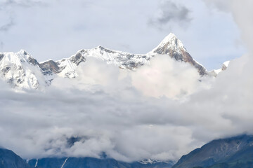 Alpine Peaks Emerging Through Clouds - Majestic Snowcapped Mountain Landscape