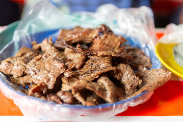 Close-up Appetizing Grilled Cecina Dish on a Plastic Plate