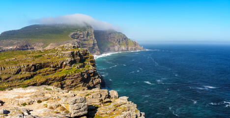 View of Cape Point from the Cape of Good Hope with the upper lighthouse (built in 1859) shrouded in mist, which is why in 1919,  the lower one was built. Cape Town. Western Cape. South Africa.