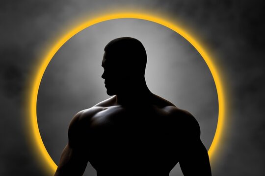 Silhouette of muscular male in front of glowing circle