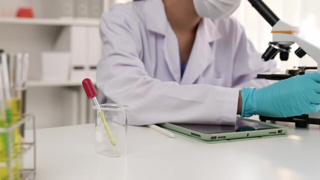 Laboratory chemistry researcher develop new medicine or cure using microscope. Technological advance of healthcare with scientific expertise with laboratory microbiology equipment. Slow motion. Rigid.