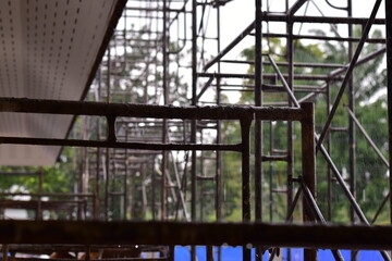 Obraz premium Scaffolding for building improvements, Renovation scaffolding enveloping historical building facade