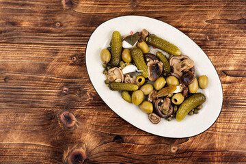 salted cucumbers, marinated mushrooms and olives
