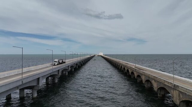 Aerial view of the two parallel lanes of the long bridge that connects Progreso, Yucat&aacute;n to the remote terminal. A trailer truck drives across the left lane