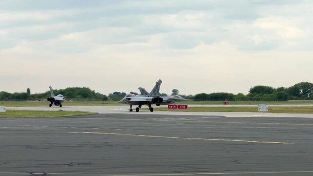 Three Military Rafale Jet Fighter Aircraft Taxiing Out to the Runway
