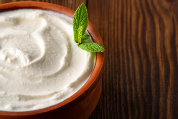 Traditional yogurt, full-fat or nonfat. Yogurt made from cow's or goat's milk on wooden background
