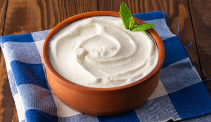Traditional yogurt, full-fat or nonfat. Yogurt made from cow's or goat's milk on wooden background