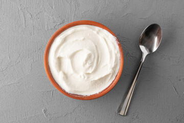 Traditional yogurt, full-fat or nonfat. Yogurt made from cow's or goat's milk on stone table 	