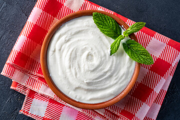 Traditional yogurt, full-fat or nonfat. Yogurt made from cow's or goat's milk on black background