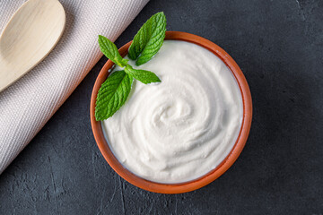 Traditional yogurt, full-fat or nonfat. Yogurt made from cow's or goat's milk on black background