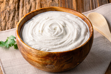Traditional yogurt, full-fat or nonfat. Yogurt made from cow's or goat's milk on wooden background